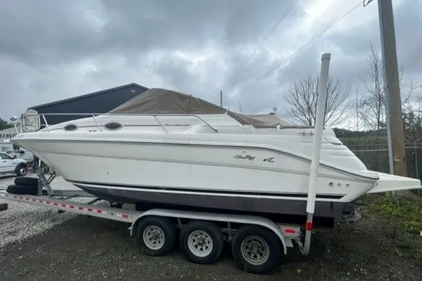 Slide: The Image of 1997 Sea Ray 270 Sundancer boat on trailer under cloudy sky. - 5