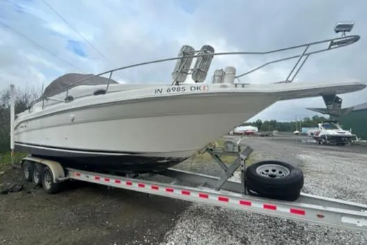 Slide: The Image of 1997 Sea Ray 270 Sundancer boat on trailer, parked outdoors. - 7