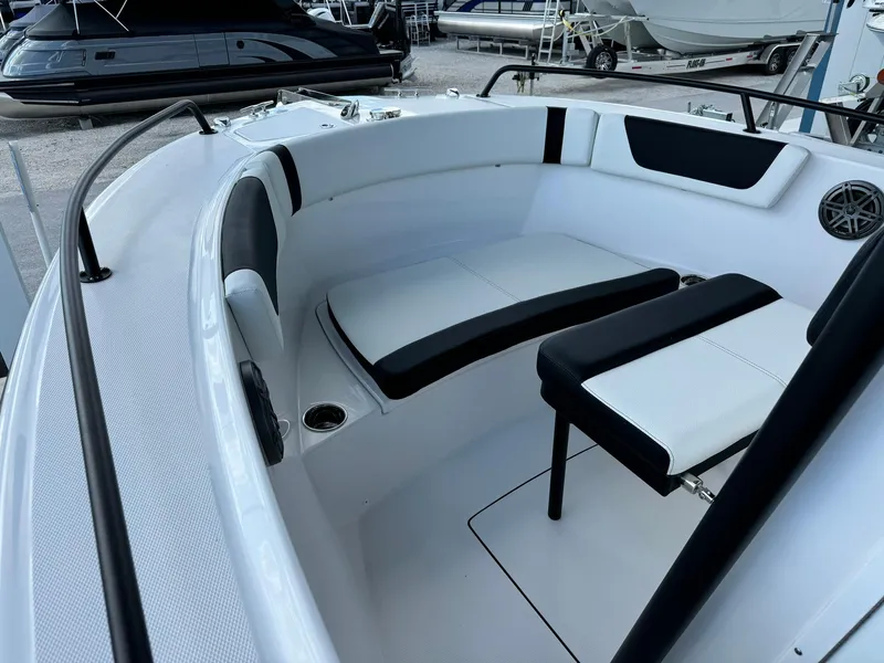 Slide: The Image of 2025 Edgewater 208 CC boat interior with white seating and black accents. - 14