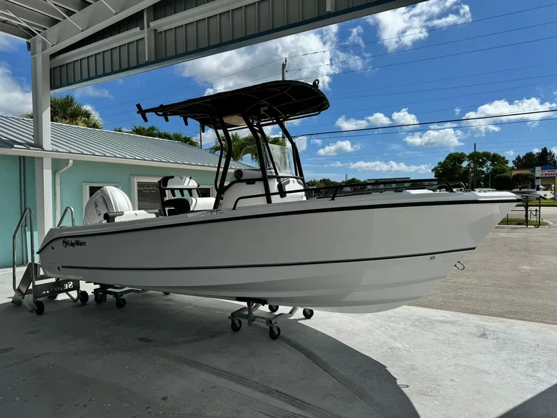 Slide: The Image of 2025 Edgewater 208 CC boat displayed outdoors under a canopy. - 3