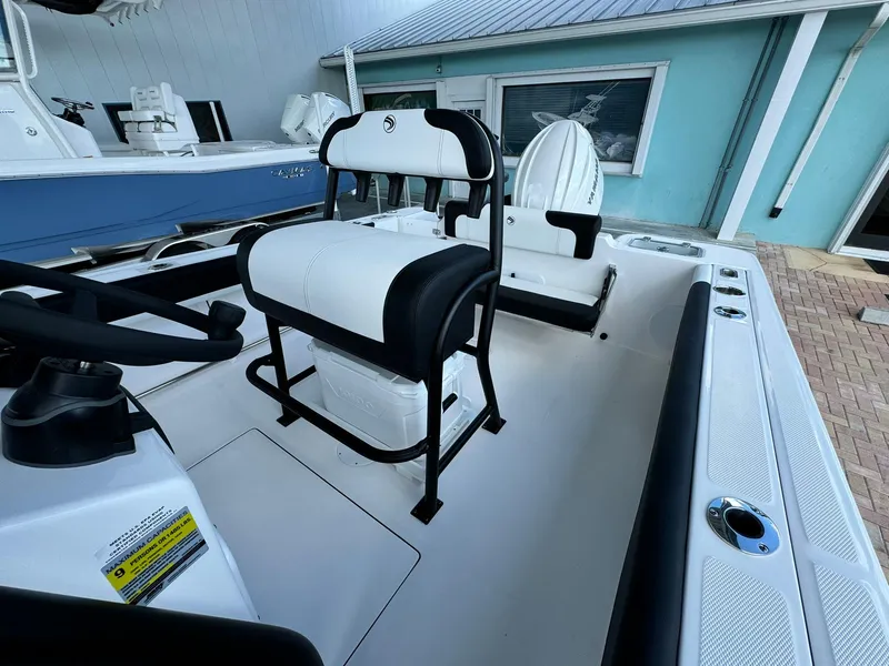 Slide: The Image of 2025 Edgewater 208 CC boat interior with seating and console, showcasing modern design. - 8