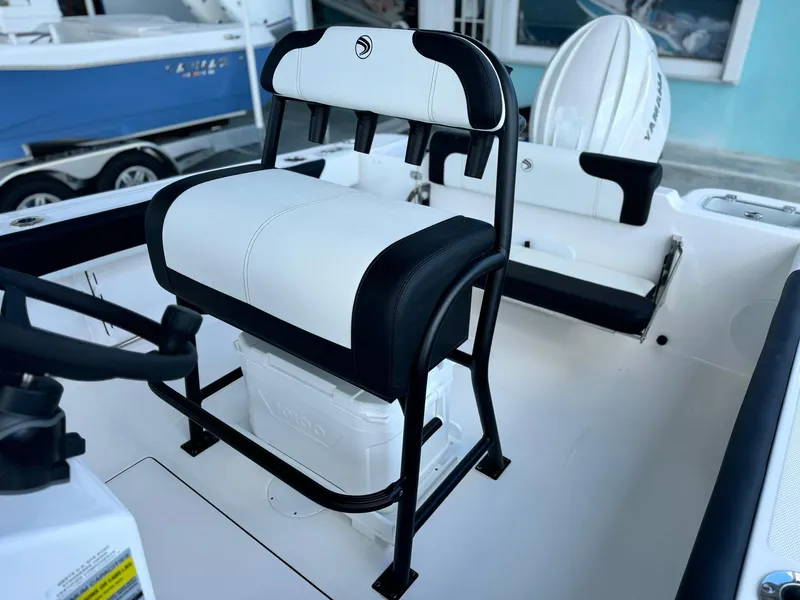 Slide: The Image of 2025 Edgewater 208 CC boat interior with cushioned seating and storage. - 9