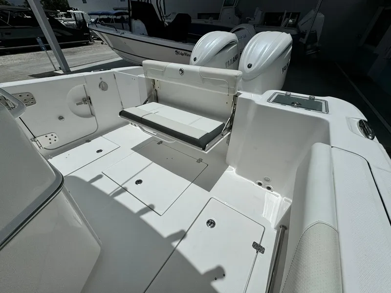 Slide: The Image of 2025 Edgewater 262 CC boat interior with seating and storage compartments. - 11