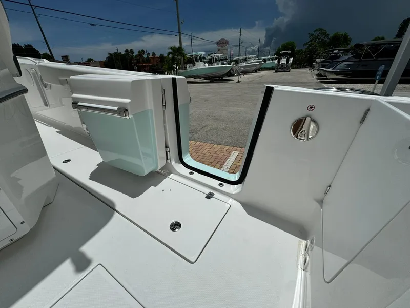 Slide: The Image of 2025 Edgewater 262 CC boat deck with open side door, showcasing sleek design. - 13