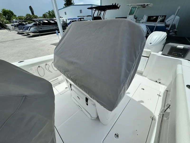Slide: The Image of 2025 Edgewater 262 CC boat with covered console, docked outdoors. - 19