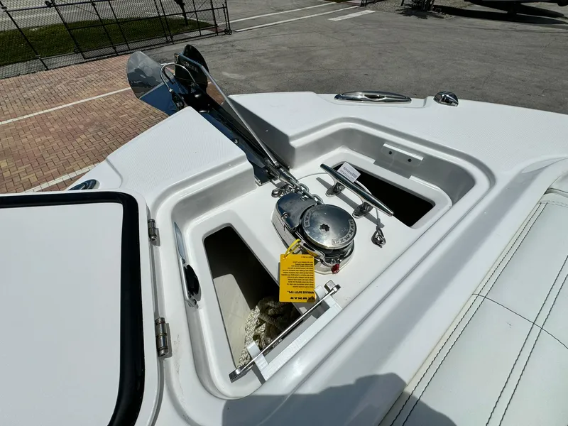 Slide: The Image of 2025 Edgewater 262 CC boat anchor compartment with winch and storage. - 31