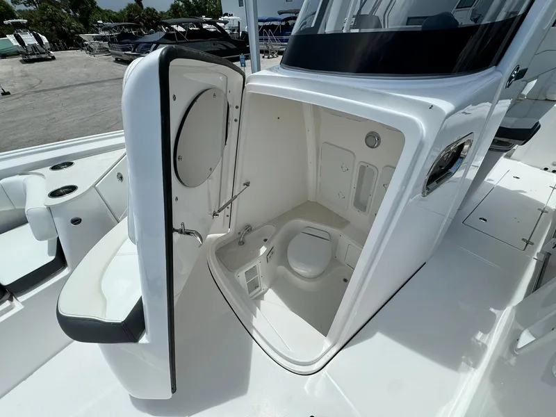 Slide: The Image of 2025 Edgewater 262 CC boat with open marine toilet compartment. - 36
