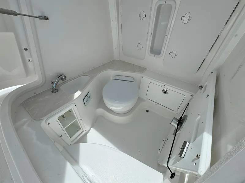 Slide: The Image of 2025 Edgewater 262 CC boat interior with compact bathroom and modern fixtures. - 38
