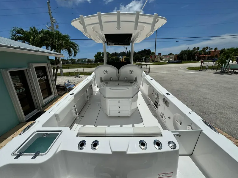 Slide: The Image of 2025 Edgewater 262 CC boat, spacious deck, modern design, sunny day. - 7