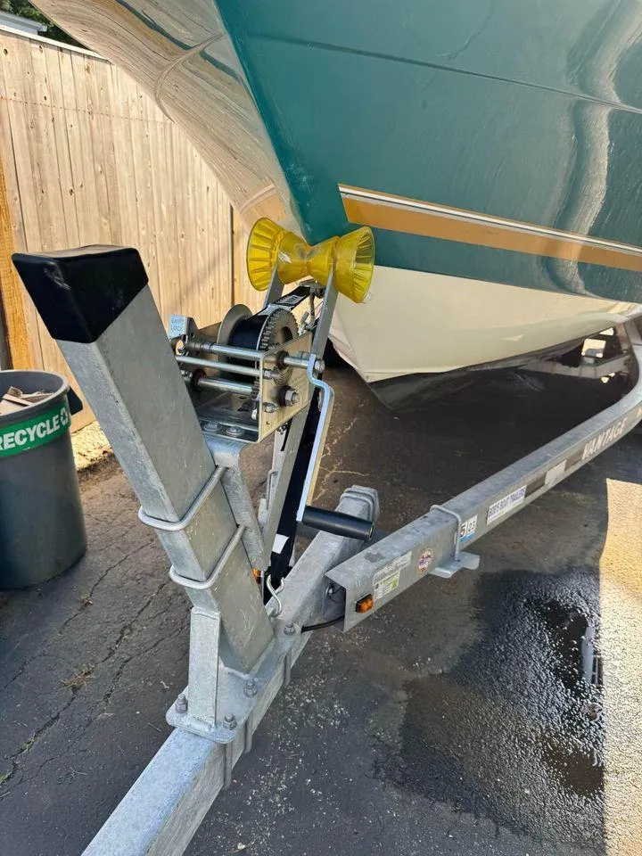 Slide: The Image of 2001 Aquasport 215 Explorer boat on trailer, showing winch and hull details. - 4