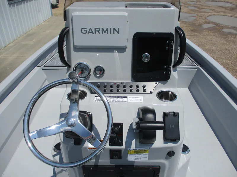 Slide: The Image of Avid 23 Mag 2025 boat console with Garmin navigation system and steering wheel. - 10