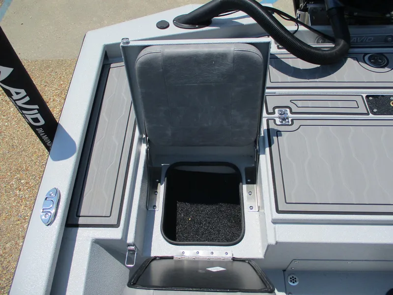 Slide: The Image of Avid 23 Mag 2025 boat storage compartment with open lid, showcasing interior space. - 14
