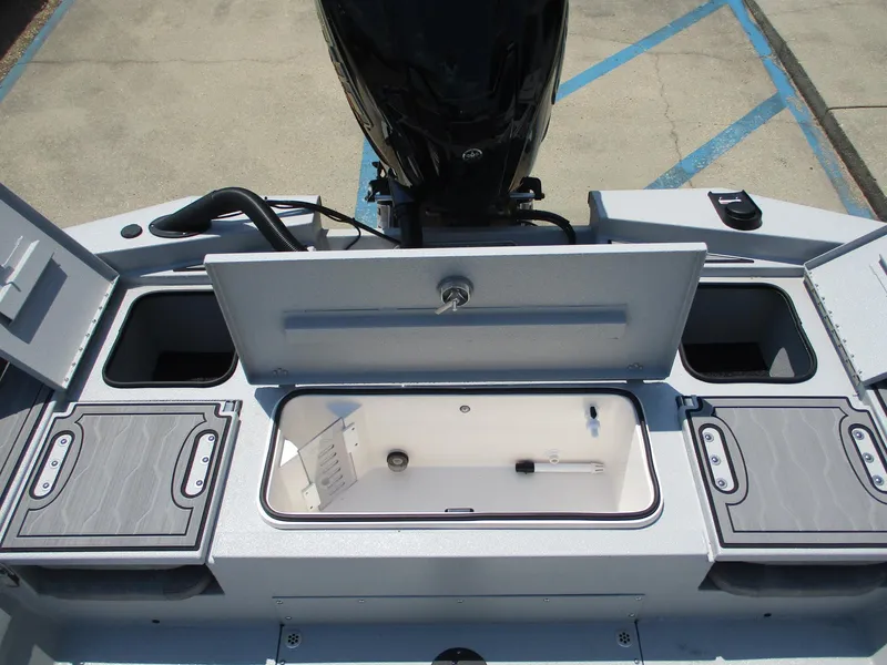 Slide: The Image of Avid 23 Mag 2025 boat storage compartments and engine view. - 15