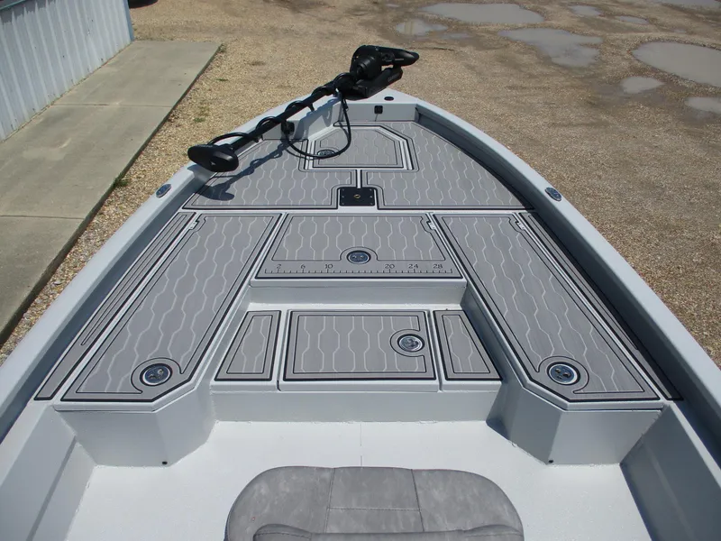 Slide: The Image of 2025 Avid 23 Mag boat deck with gray non-slip surface and storage compartments. - 16