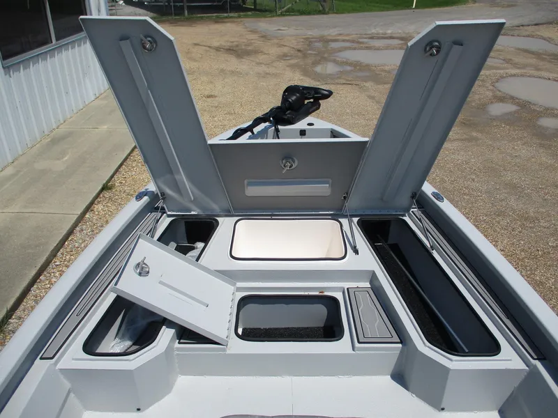 Slide: The Image of 2025 Avid 23 Mag boat with open storage compartments and clean deck design. - 17