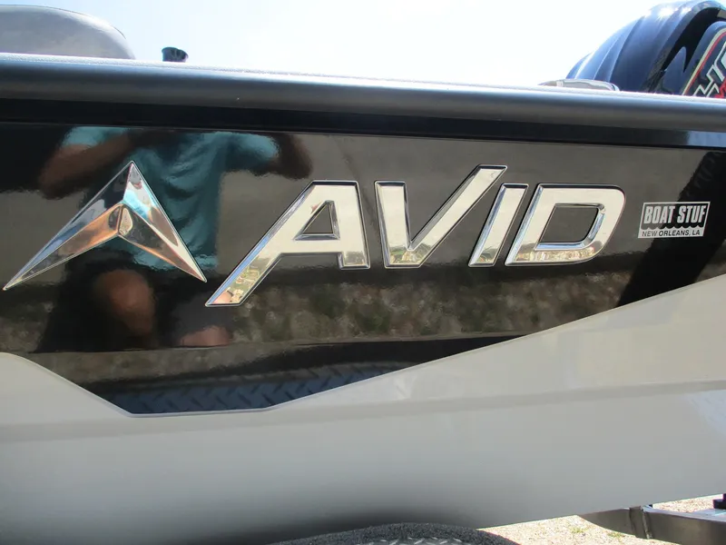 Slide: The Image of Avid 23 Mag 2025 boat logo on sleek black and white surface. - 23