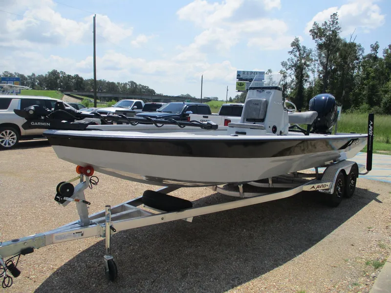 Slide: The Image of 2025 Avid 23 Mag boat on trailer in parking lot, sunny day. - 3