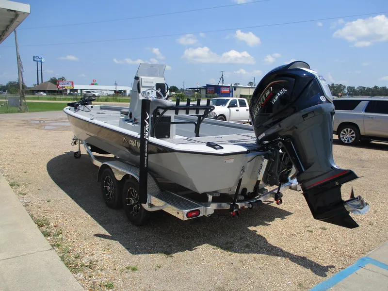Slide: The Image of Avid 23 Mag 2025 boat on trailer, parked outdoors under clear sky. - 4