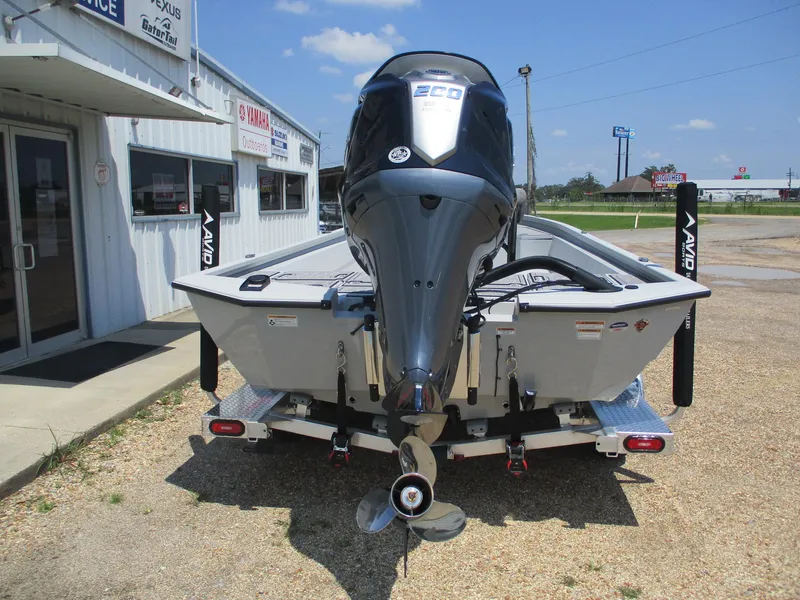 Slide: The Image of 2025 Avid 23 Mag boat with powerful outboard motor, parked outside dealership. - 5
