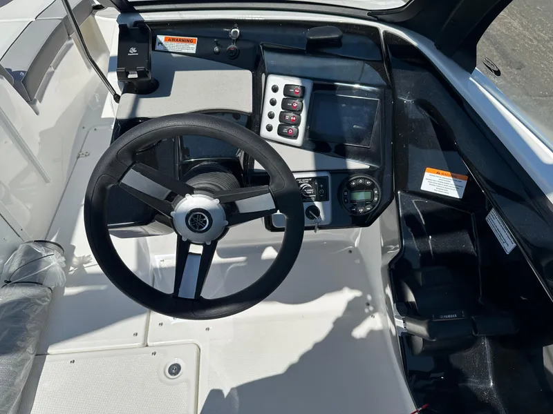 Slide: The Image of 2025 Yamaha Boats AR220 dashboard with steering wheel and control panel. - 11