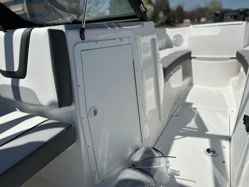 Slide: The Image of 2025 Yamaha Boats AR220 interior, showcasing sleek seating and storage compartment. - 12