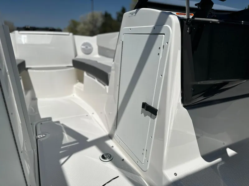 Slide: The Image of 2025 Yamaha Boats AR220 interior, featuring sleek white design and comfortable seating. - 13