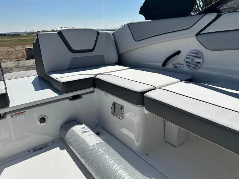 Slide: The Image of 2025 Yamaha Boats AR220 interior seating with sleek, modern design and comfortable cushions. - 14