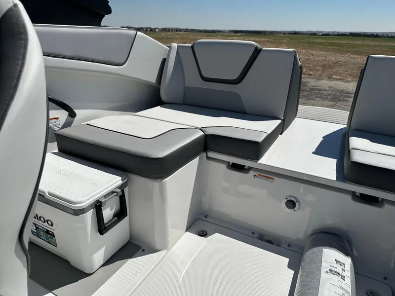 Slide: The Image of 2025 Yamaha Boats AR220 interior seating with cooler, showcasing modern design and comfort. - 15