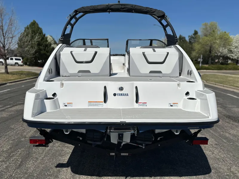 Slide: The Image of 2025 Yamaha Boats AR220 rear view, showcasing sleek design and spacious seating. - 3