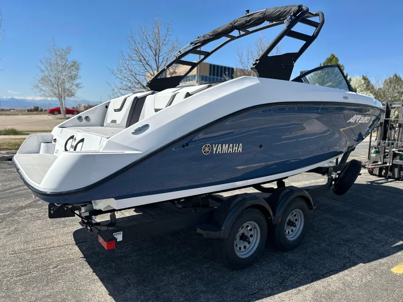 Slide: The Image of 2025 Yamaha Boats AR220 on trailer, sleek design, parked outdoors. - 4