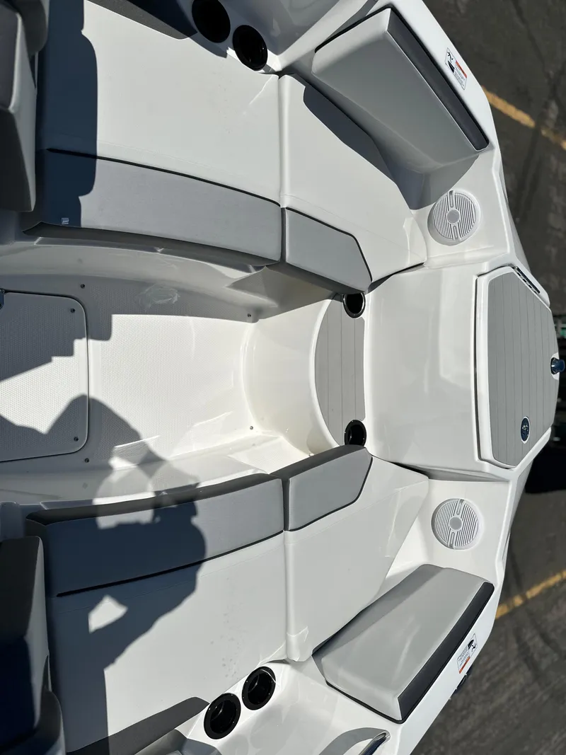 Slide: The Image of 2025 Yamaha Boats AR220 interior with sleek seating and cup holders. - 7