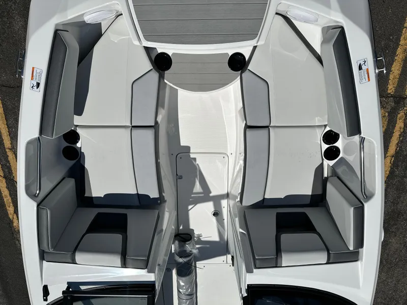 Slide: The Image of 2025 Yamaha Boats AR220 interior with gray seating and cup holders, top view. - 8