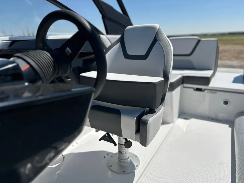 Slide: The Image of 2025 Yamaha Boats AR220 interior with modern steering and seating design. - 9