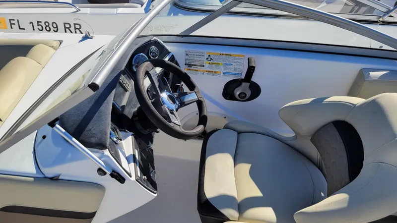 Slide: The Image of 2020 Hurricane SD 217 PROJECT boat interior with steering wheel and beige seating. - 16