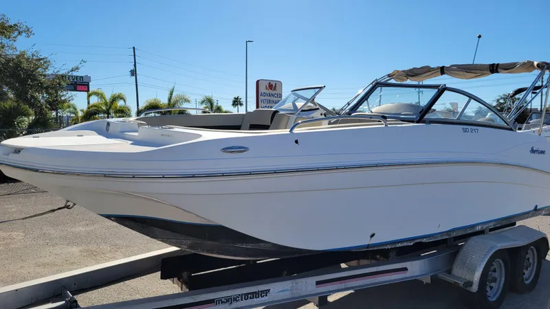 Slide: The Image of 2020 Hurricane SD 217 PROJECT boat on trailer, sunny day, palm trees in background. - 6