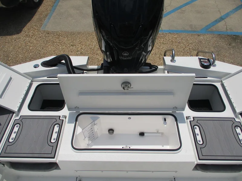 Slide: The Image of 2025 Avid 23 Fusion boat storage compartments and engine view. - 13