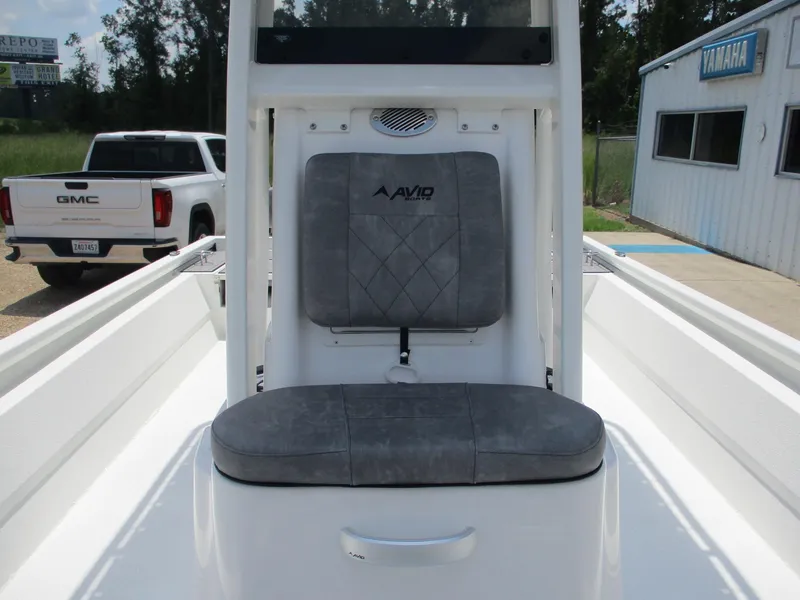 Slide: The Image of Avid 23 Fusion 2025 boat seat with gray upholstery, outdoor setting. - 15