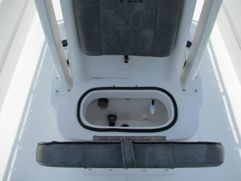 Slide: The Image of Avid 23 Fusion 2025 boat interior with storage compartment and cushioned seating. - 16