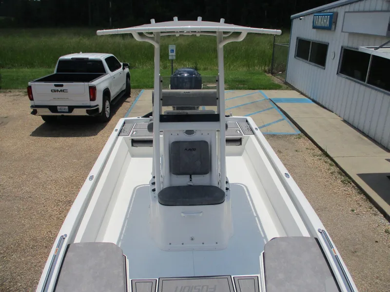 Slide: The Image of Avid 23 Fusion 2025 boat with T-top, parked near a GMC truck. - 19