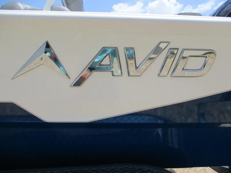 Slide: The Image of Avid 23 Fusion 2025 boat logo on white and blue hull. - 23