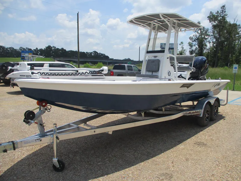 Slide: The Image of 2025 Avid 23 Fusion boat on trailer, parked outdoors under a clear sky. - 3
