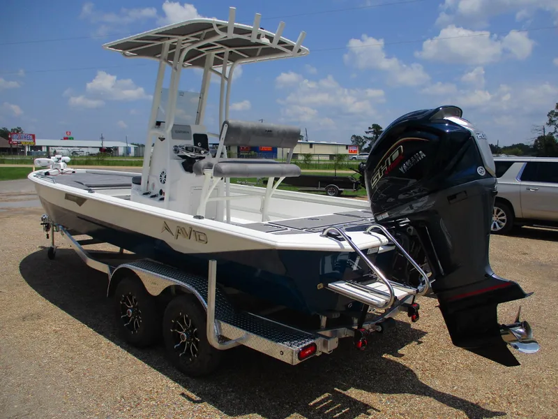 Slide: The Image of 2025 Avid 23 Fusion boat on trailer with outboard motor, parked outdoors. - 4