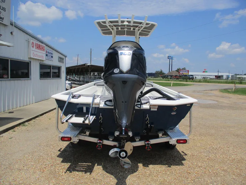Slide: The Image of 2025 Avid 23 Fusion boat with Yamaha outboard motor, parked outside dealership. - 5