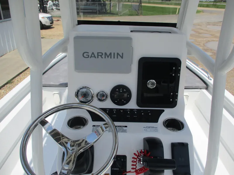 Slide: The Image of Avid 23 Fusion 2025 boat dashboard with Garmin navigation system and steering wheel. - 7