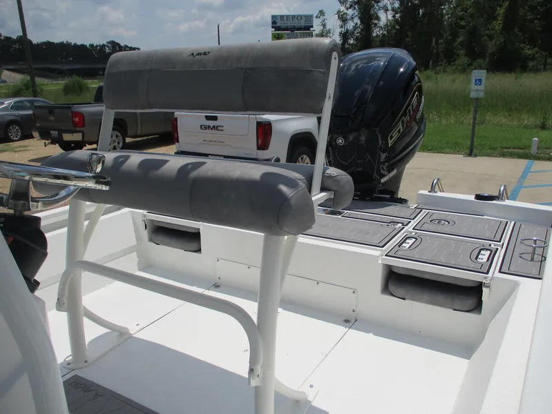 Slide: The Image of 2025 Avid 23 Fusion boat with seating and motor, parked outdoors. - 8