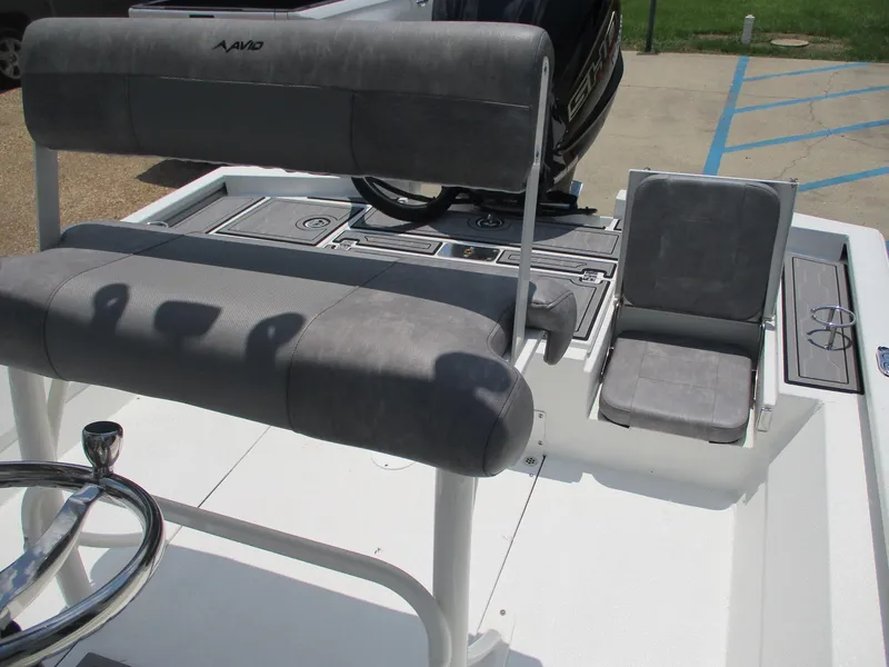 Slide: The Image of Avid 23 Fusion 2025 boat interior with gray seating and steering wheel. - 9