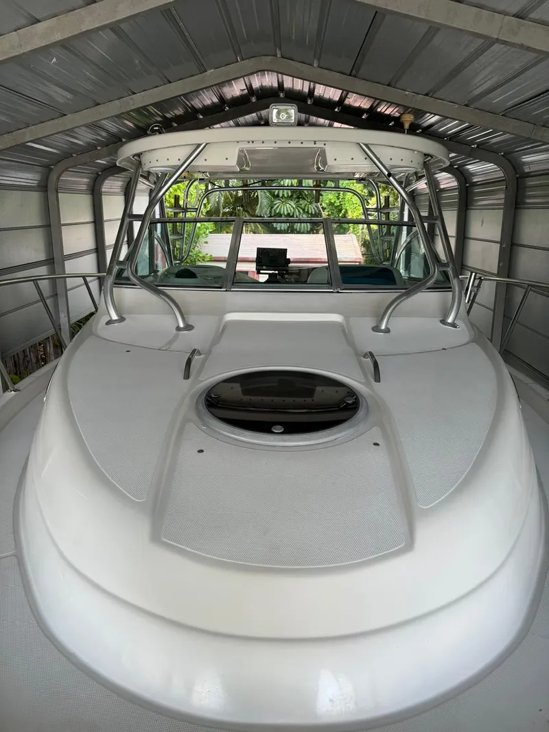 Slide: The Image of 2005 Seaswirl Striper 2901 Walkaround O/B in covered storage, showcasing sleek design and spacious deck. - 15