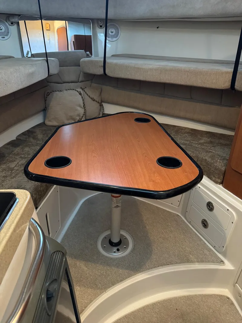 Slide: The Image of 2005 Seaswirl Striper 2901 Walkaround O/B cabin interior with triangular table and seating. - 17