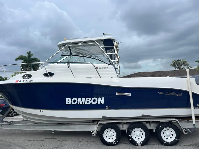 Slide: The Image of 2005 Seaswirl Striper 2901 Walkaround O/B boat on trailer under cloudy sky. - 2
