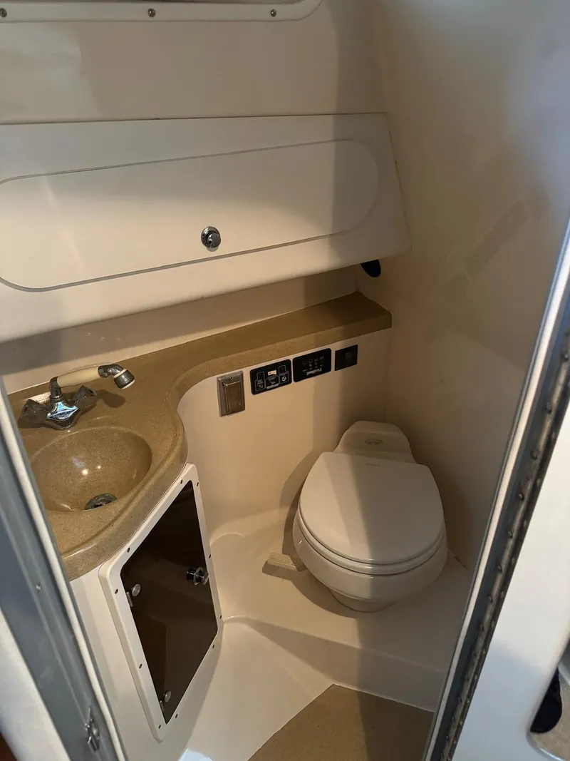 Slide: The Image of 2005 Seaswirl Striper 2901 Walkaround O/B boat bathroom interior with sink and toilet. - 6